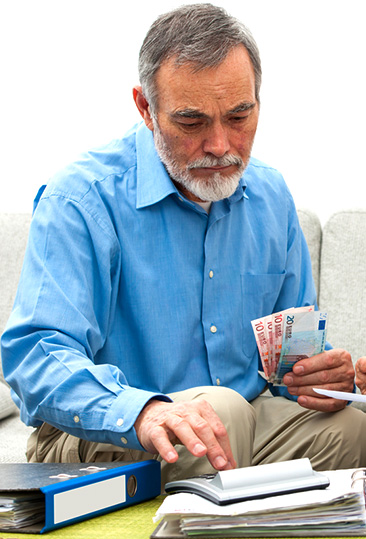 A man reviewing his tax paperwork with worry
