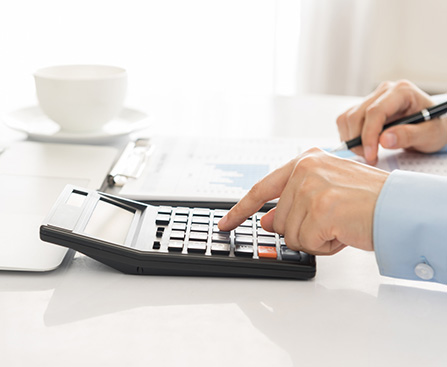 A calculator and tax forms on a desk